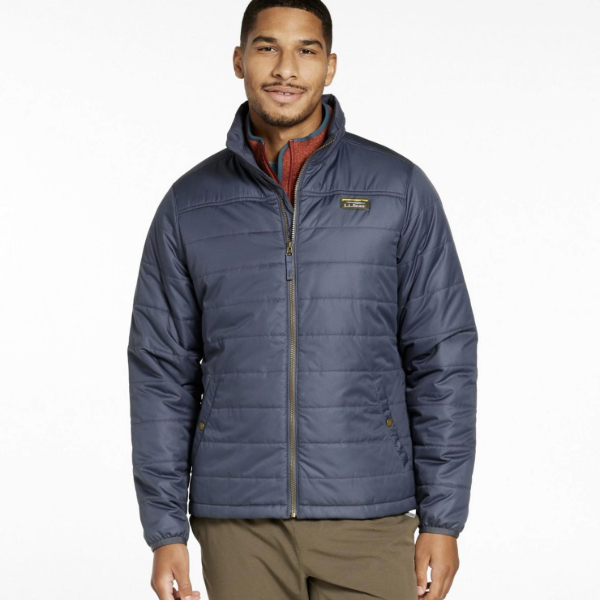 a man wearing a puffer jacket over pants
