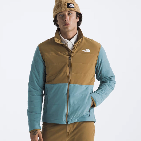 a man wearing a full zip sweatshirt jacket over pants and a shirt 