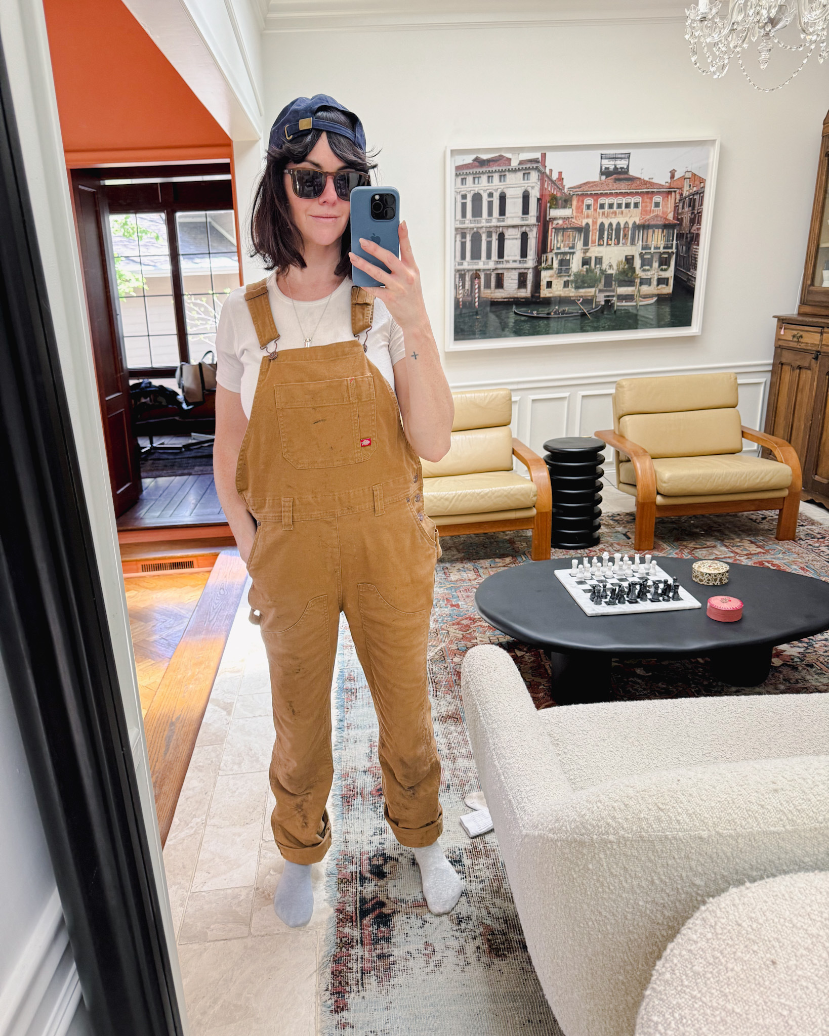 A woman in dirty overalls after spending the afternoon gardening