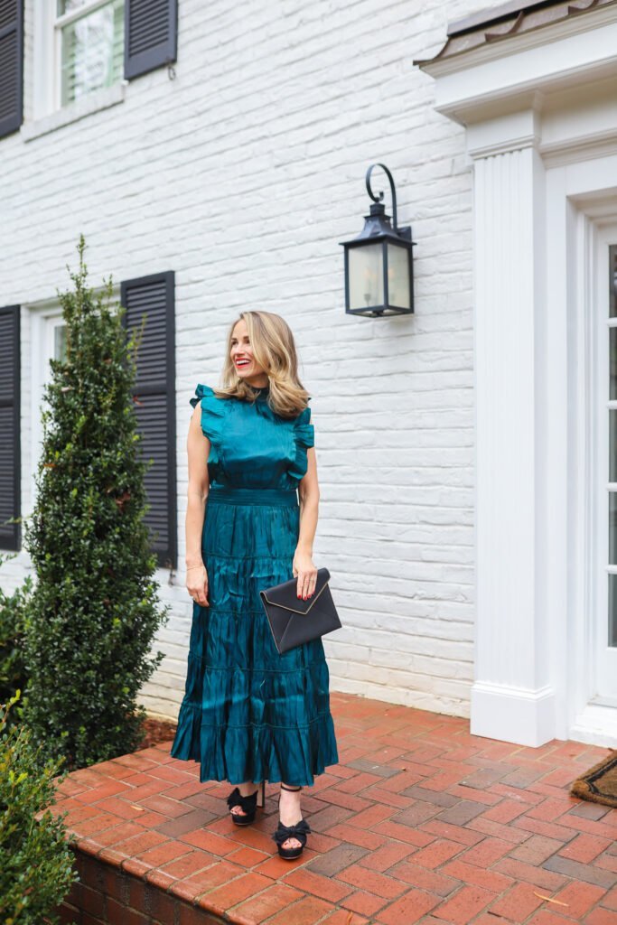 woman wearing Take a Glance Emerald Green Tiered Mock Neck Midi Dress one of the holiday cocktail dresses 