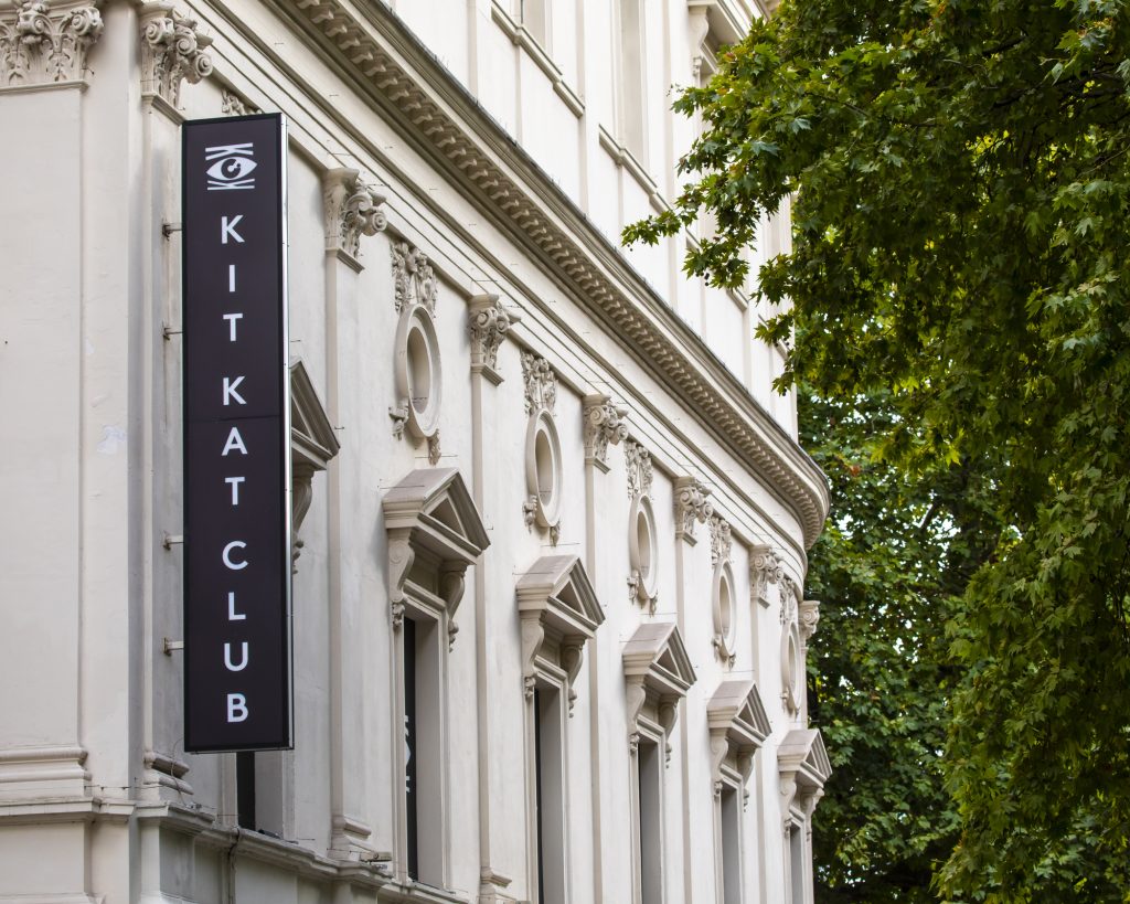 London, UK - September 14th 2022: A sign on the exterior of the Kit Kat Club at the Playhouse Theatre, located on Northumberland Avenue in London, UK. A white building The sign is black with white writing.