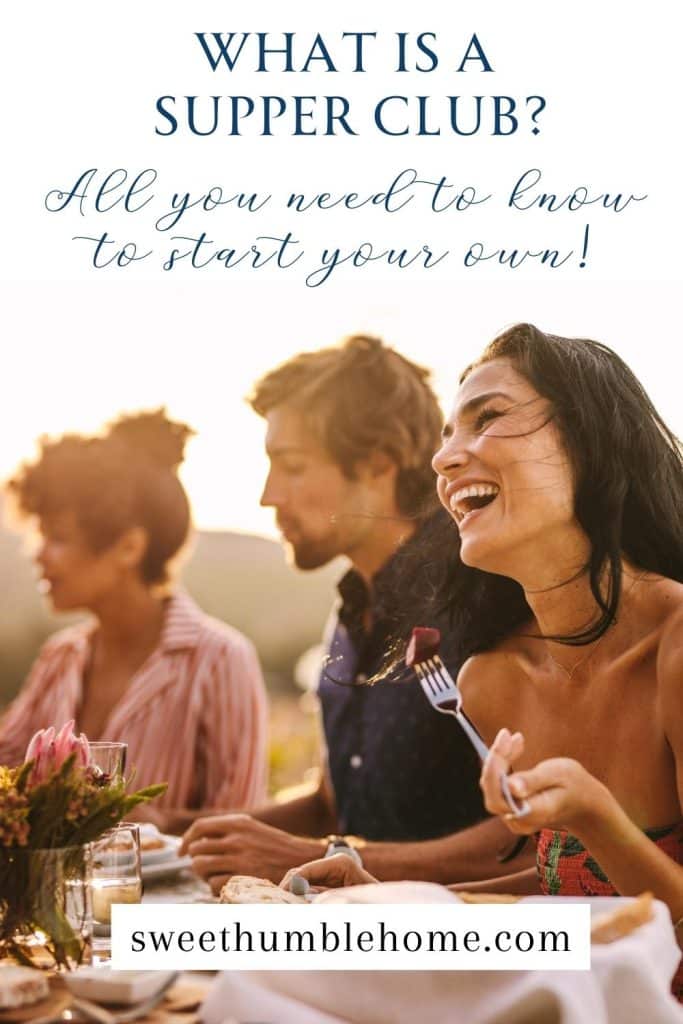 A group of friends dining outside for a supper club. They are ethnically diverse and eating at a table set in front of a far off mountain or hill. The woman near the front is laughing.