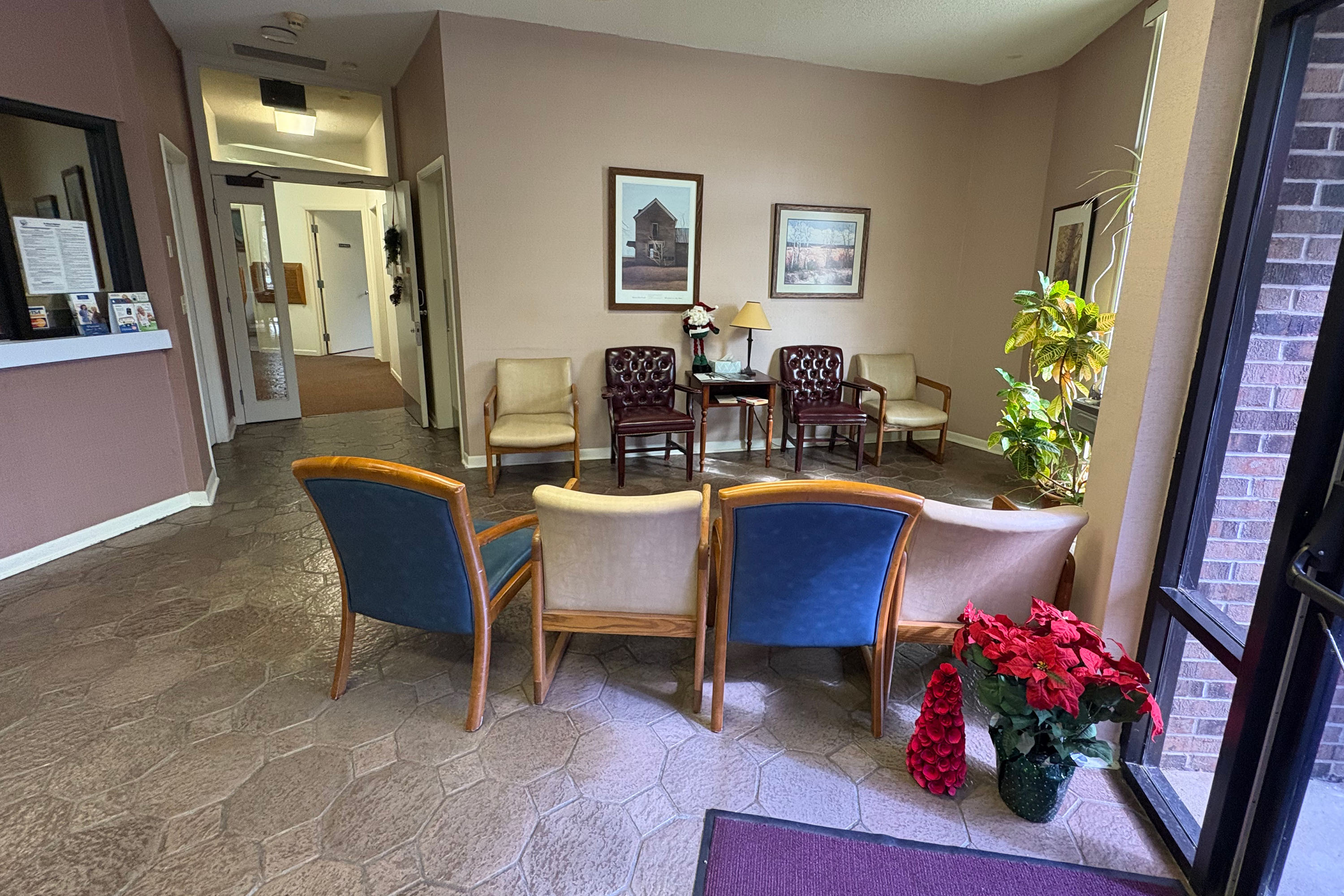 A small patient waiting room has two rows of 4 chairs facing each other, ready for patients.