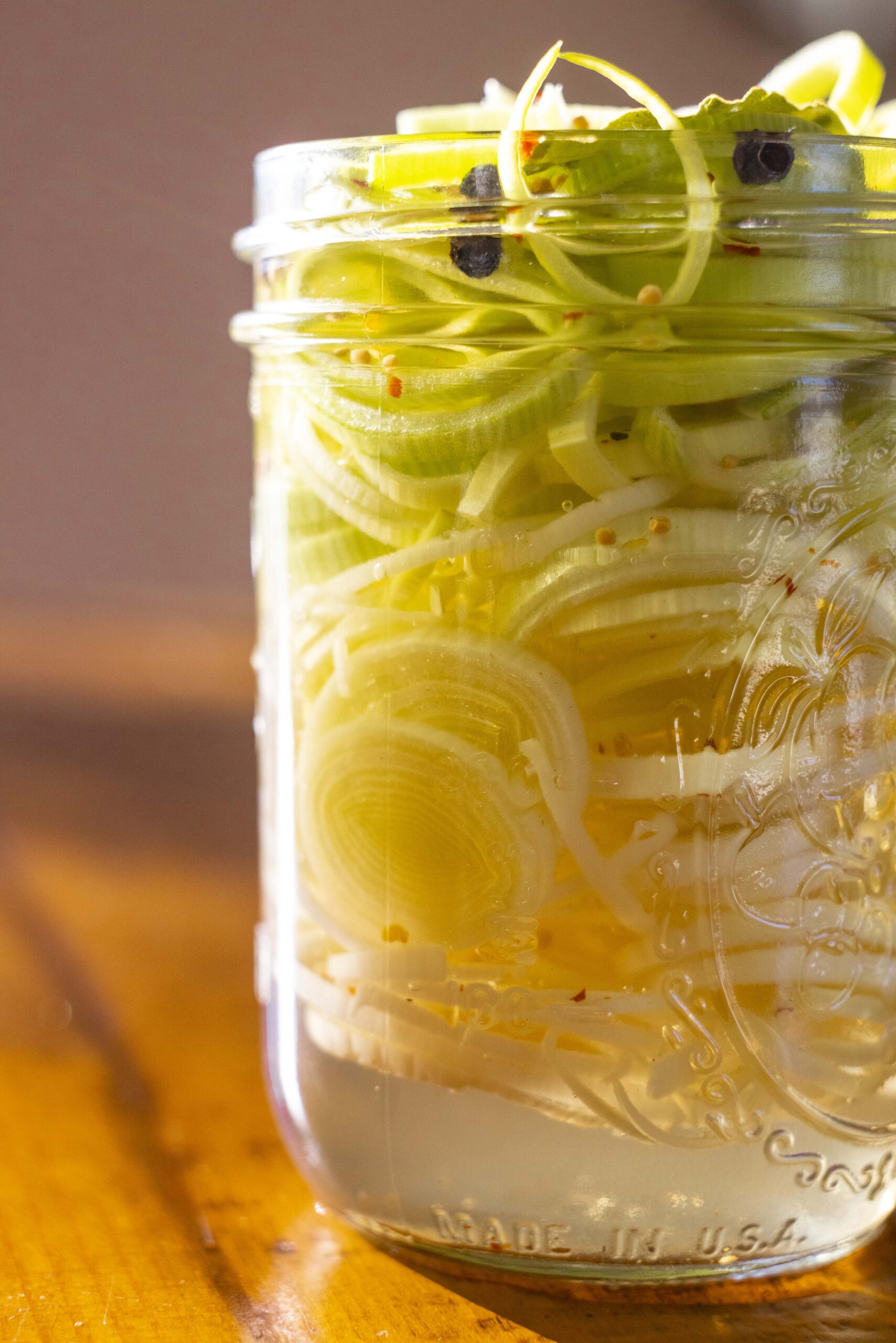 A mason jar filled with pickled leeks