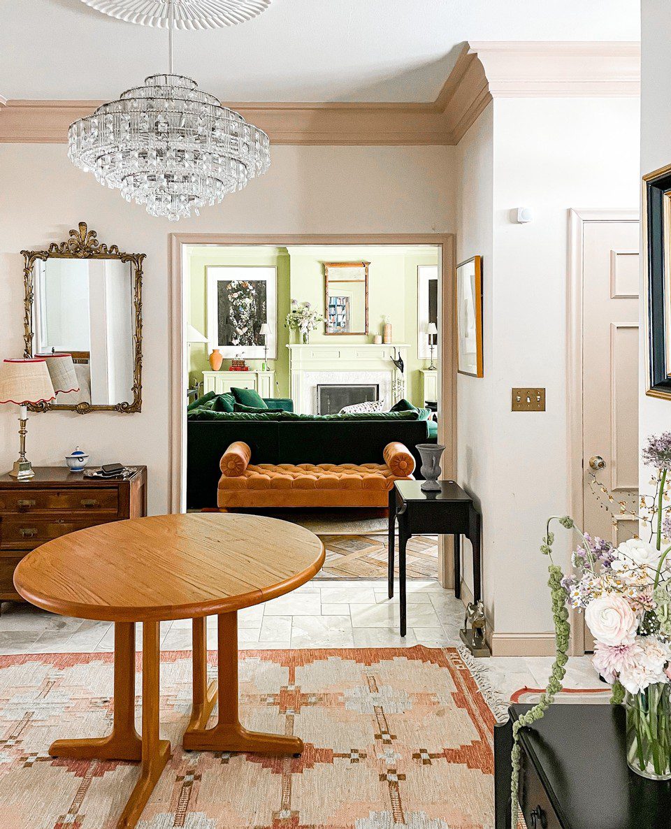 A pink vintage rug from Chairish grounds a cozy entryway in a 1950s home